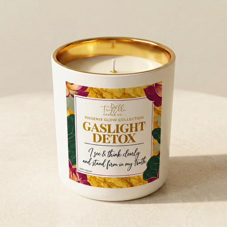 Gaslight Detox candle from the Phoenix Glow Collection in an ivory jar with a gold interior