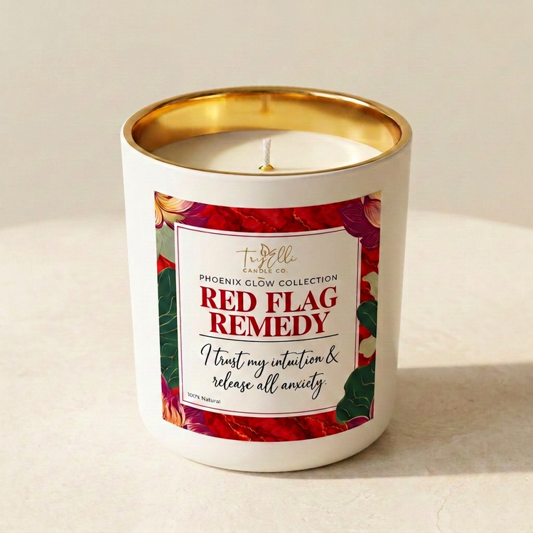 Red Flag Remedy candle from the Phoenix Glow Collection in an ivory jar with a gold interior